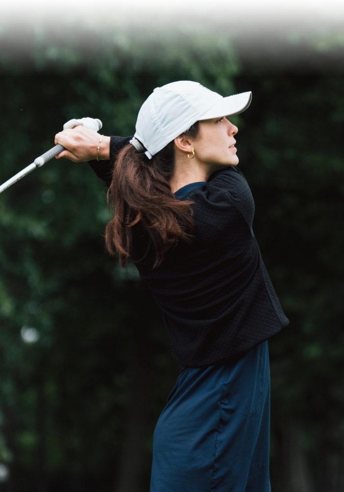 A woman playing golf